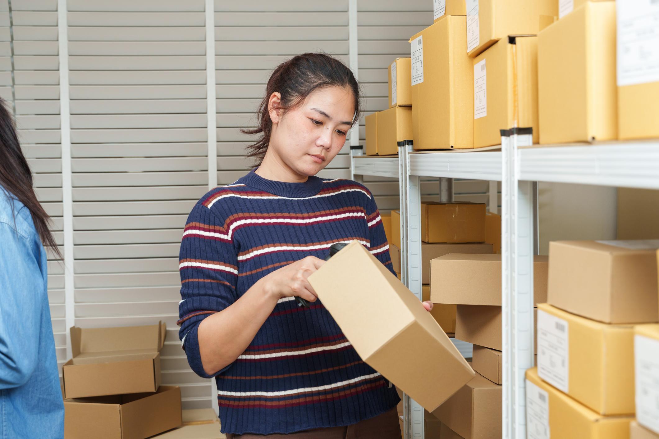 Independent retailer checking an outdoor product shipment